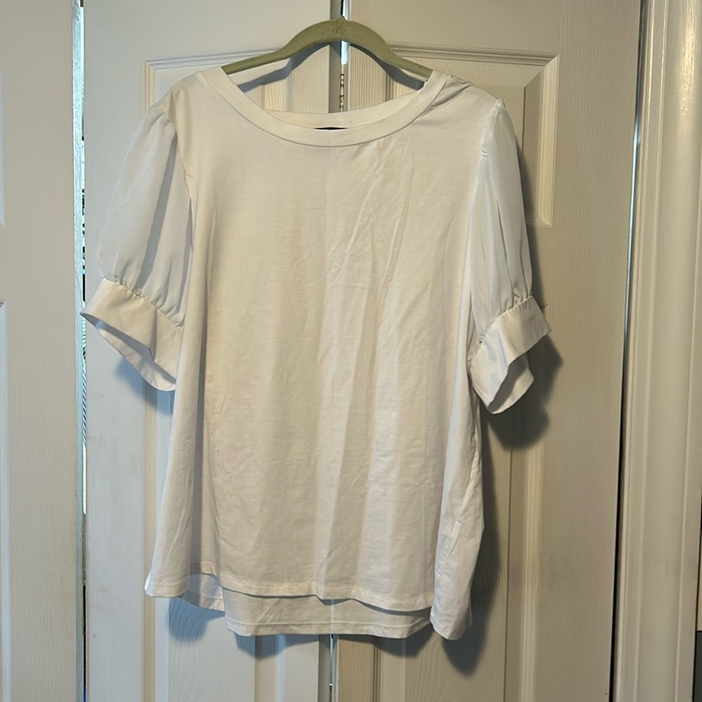 Cute white top. Tee shirt material with dressed up shirt sleeves.